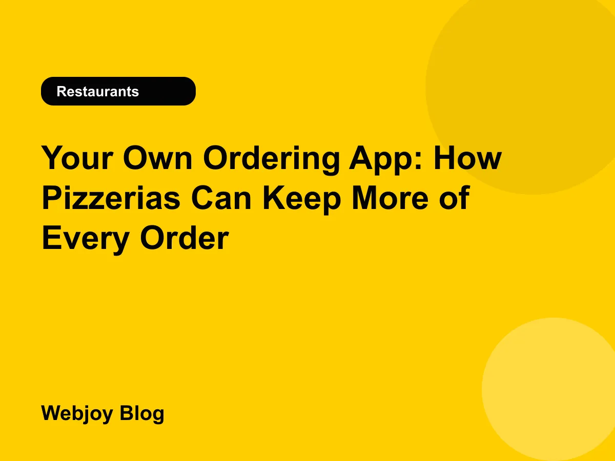 Pizza box on a counter next to a phone showing a pizzeria's own branded ordering app